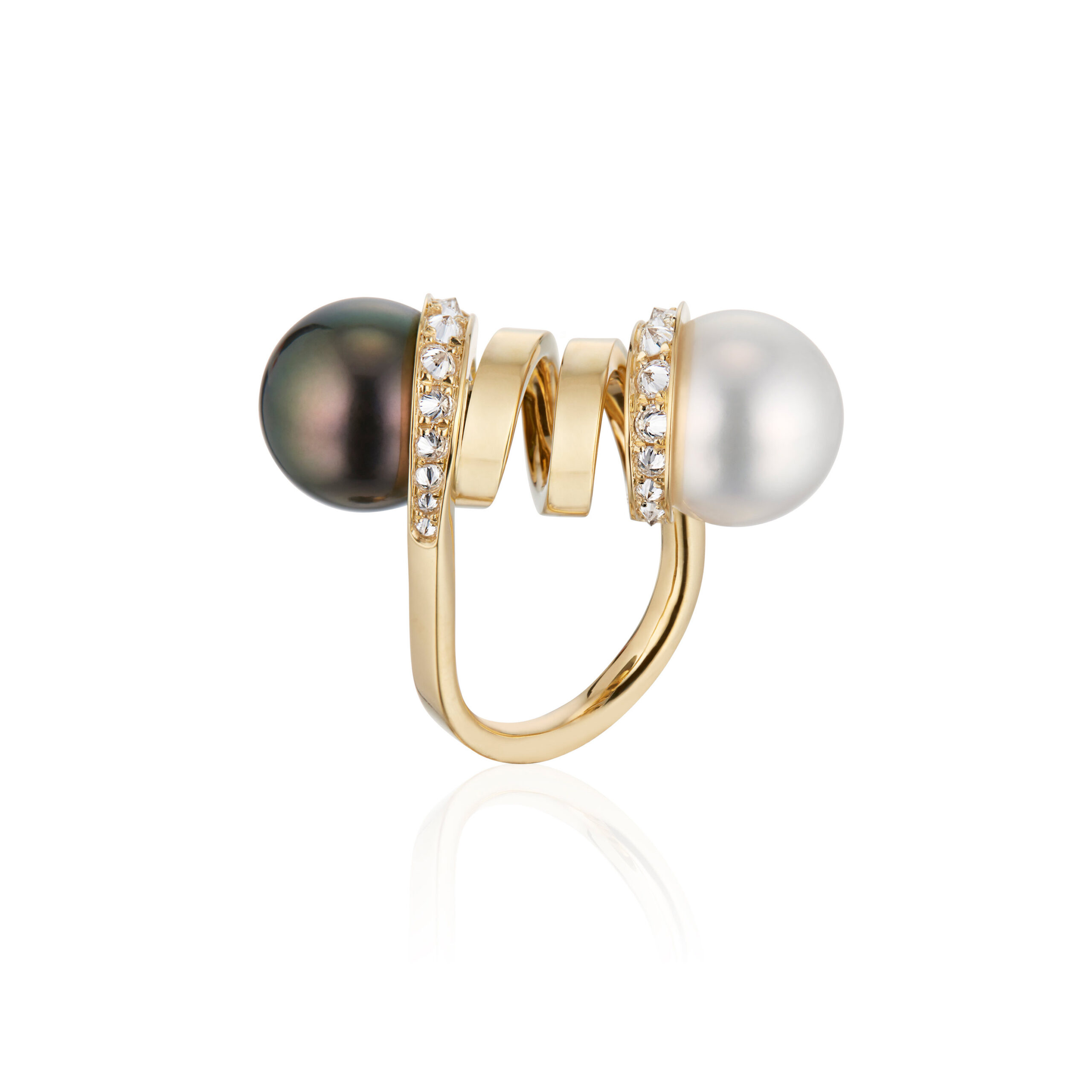 This is a profile photo of the Renisis Double Pearl Curl Ring, featuring 18K yellow gold with inverted diamonds and one white South Sea and one black Tahitian Pearl. Both contrasting pearls are on opposite side of the curled gold.