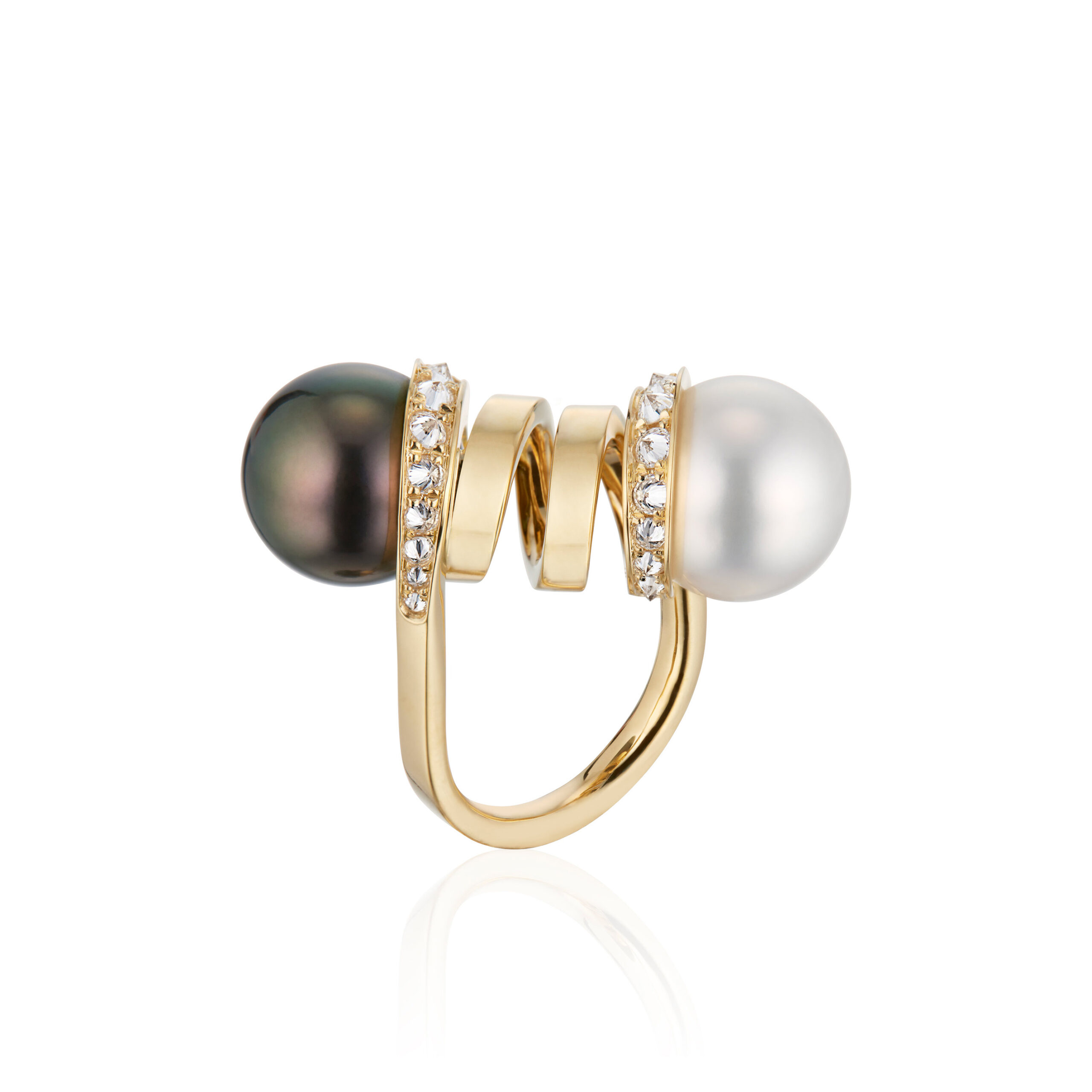 This is a profile photo of the Renisis Double Pearl Curl Ring, featuring 18K yellow gold with inverted diamonds and one white South Sea and one black Tahitian Pearl. Both contrasting pearls are on opposite side of the curled gold.
