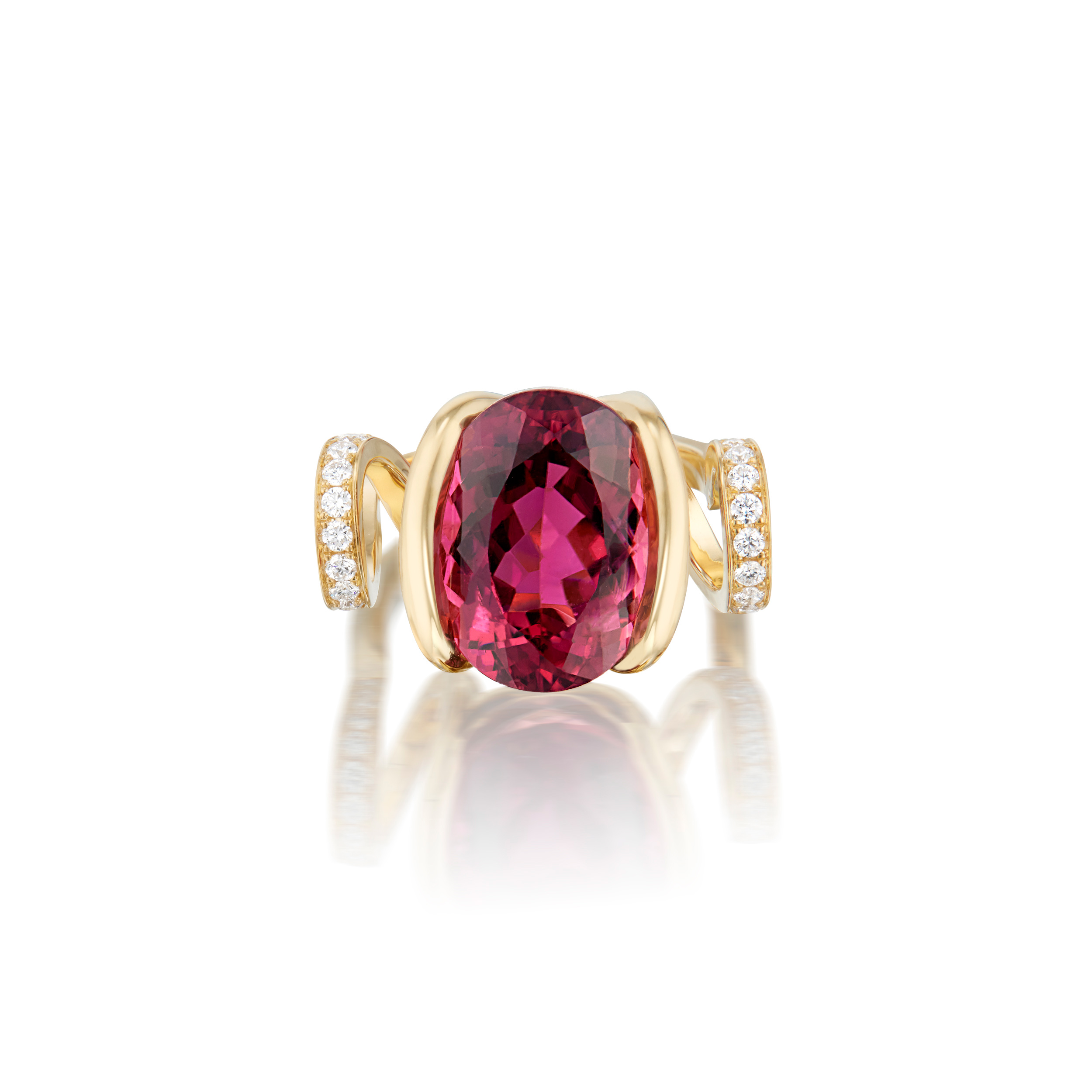 This is a front view, set down, of Renisis by Sardwell's Fire Curl Ring. Here, the gem stone can be seen clearly for size. It is a large pink tourmaline center and 18K yellow gold with pavé diamonds. Its unique design featured a curled body and setting.